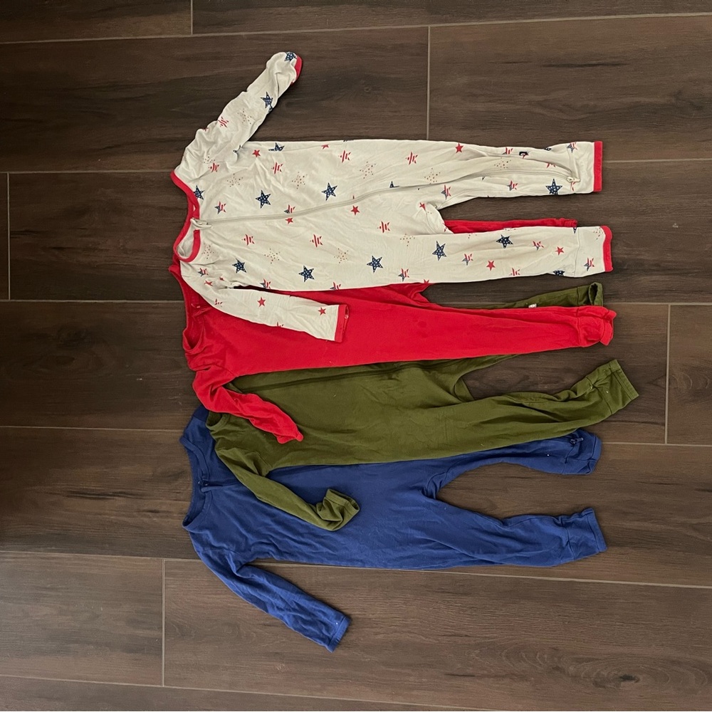 Kyte baby Bundle. Set of Four Baby Onesies in Red, Green, Blue, and Star Print